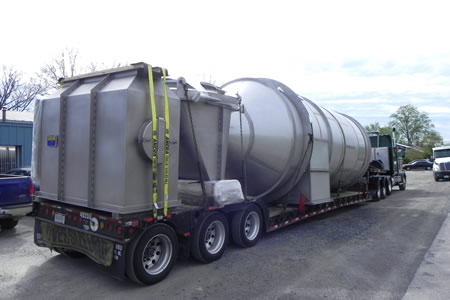 Stainless steel container on the back of a flatbed trailer
